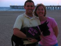 Katie & Shawn hold Belle with their announcement at Hueneme Beach